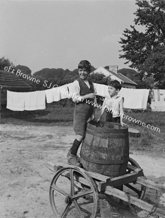 BOYS WITH WATER BARREL